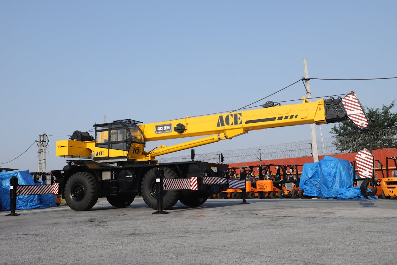 A 40 ton ACE rough terrain crane parked in an industrial yard in Faridabad, India.